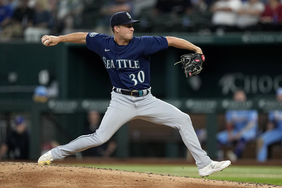 Seattle Mariners relief pitcher Trevor Gott winds up to throw to the Texas Rangers in the sixth inning of a baseball game, Sunday, June 4, 2023, in Arlington, Texas. (AP Photo/Tony Gutierrez)