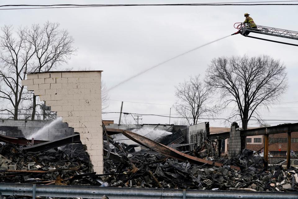 Clinton Township fire fighters continue to extinguish hot spots that can be seen rising on Tuesday, March 5, 2024 after multiple explosions occurred last night at the Select Distributors in Clinton Township at 15 Mile Road.
