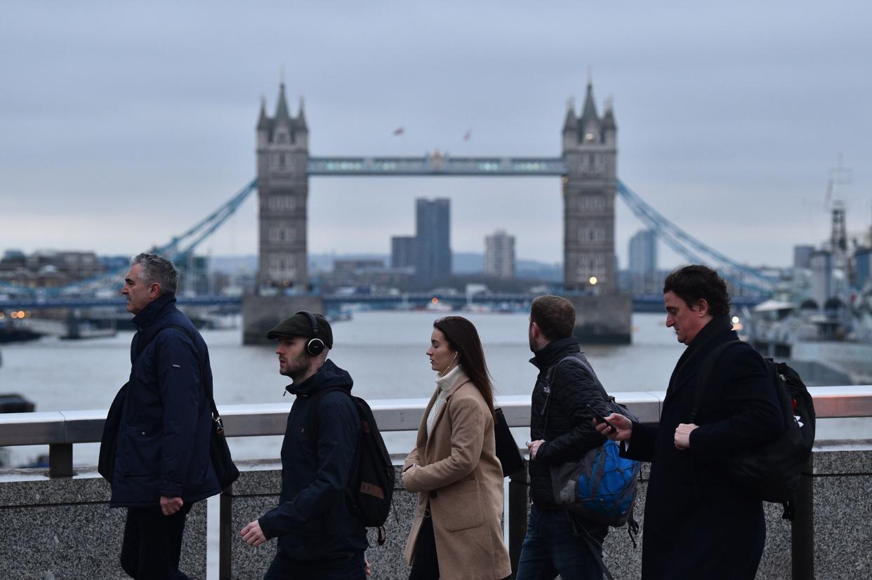 Commuters walk along London Bridge toward the City of London with Tower Bridge in the background in London on January 31, 2020 on the day that the UK formally leaves the European Union. - Britain on January 31 ends almost half a century of integration with its closest neighbours and leaves the European Union, starting a new -- but still uncertain -- chapter in its long history. (Photo by Glyn KIRK / AFP) (Photo by GLYN KIRK/AFP via Getty Images)