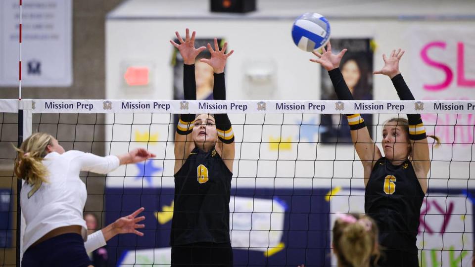 Hannah Garrett hits for the Royals while Ava Van Brasch (8) and Nina Moutafov (6) defend. Cowitz Gymnasium at Mission Prep was full and loud as the San Luis Obispo Tigers girls volleyball team beat the Royals 3-0 Sept. 26, 2023.