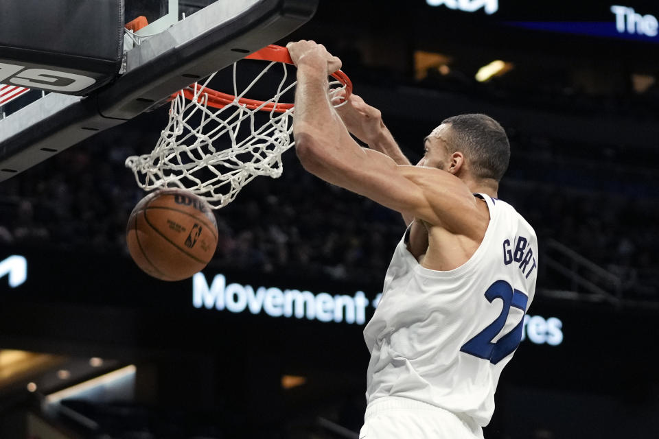 Minnesota Timberwolves center Rudy Gobert makes an uncontested dunk against the Orlando Magic during the first half of an NBA basketball game, Tuesday, Jan. 9, 2024, in Orlando, Fla. (AP Photo/John Raoux)