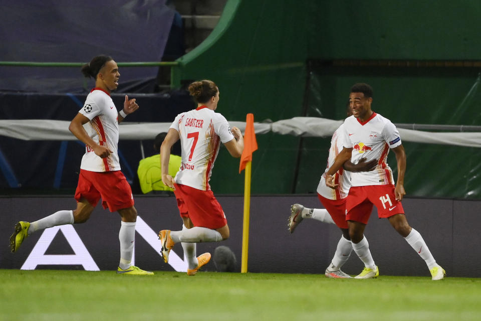 Tyler Adams (right) celebrates with teammates after scoring the goal that sent RB Leipzig to the UEFA Champions League semifinals. (Lluis Gene/Getty Images)