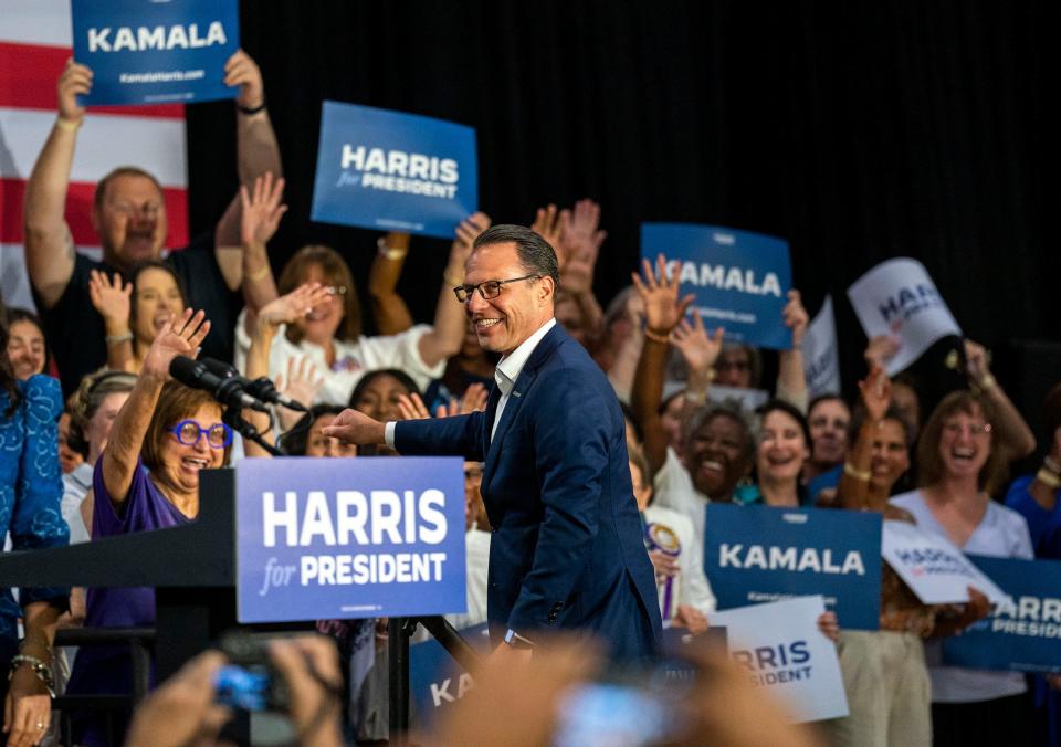 Pennsylvania Gov. Josh Shapiro greets the crowd alongside Michigan Gov. Gretchen Whitmer at a campaign rally for Vice President Kamala Harris at Wissahickon High School in Ambler on Monday.