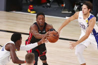 Miami Heat forward Bam Adebayo, top center, Indiana Pacers guard Victor Oladipo, lower left, and forward Doug McDermott, right, go after the ball during the second half of Game 3 of an NBA basketball first-round playoff series, Saturday, Aug. 22, 2020, in Lake Buena Vista, Fla. (Kim Klement/Pool Photo via AP)