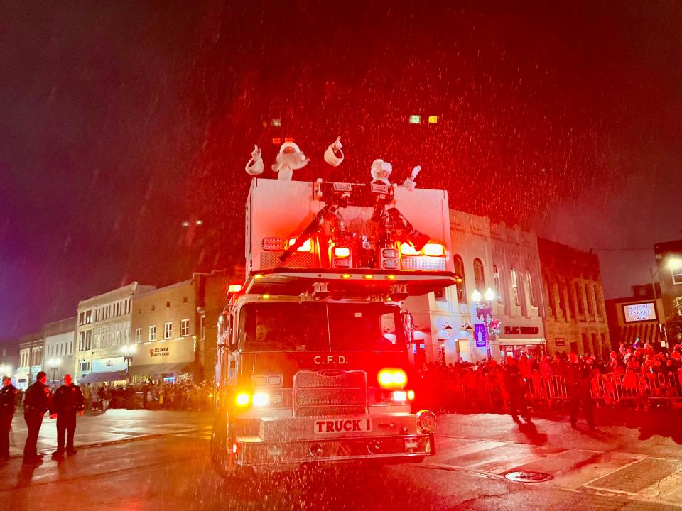 Santa and Mrs. Claus greet parade goers atop a Columbia Fire & Rescue engine during the 37th annual Columbia Main Street Christmas Parade.