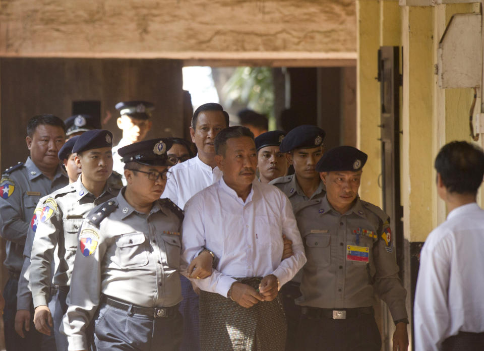 Kyi Lin, center, the gunman who shot a prominent Muslim lawyer who was a close adviser of Myanmar leader Aung San Suu Kyi, is escorted by police at Yangon Northern District Court in Yangon, Myanmar, Friday, Feb. 15, 2019. The court found Kyi Lin guilty of premeditated murder and illegal weapons possession and sentenced to death for the Jan. 29, 2017 shooting of lawyer Ko Ni in broad daylight at Yangon airport. (AP Photo/Thein Zaw)