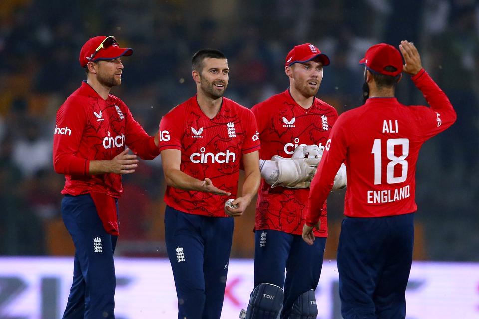 England's Mark Wood, second left, celebrates with teammates after taking the wicket of Pakistan's Haider Ali during the fifth twenty20 cricket match between Pakistan and England, in Lahore, Pakistan, Wednesday, Sept. 28, 2022. (AP Photo/K.M. Chaudary)