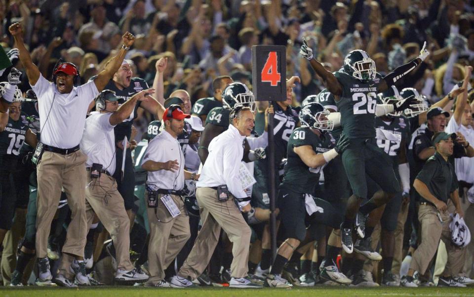 Michigan State players and coaches celebrate a 24-20 win over Stanford in the Rose Bowl NCAA college football game Wednesday, Jan. 1, 2014, in Pasadena, Calif. (AP Photo/Mark J. Terrill)