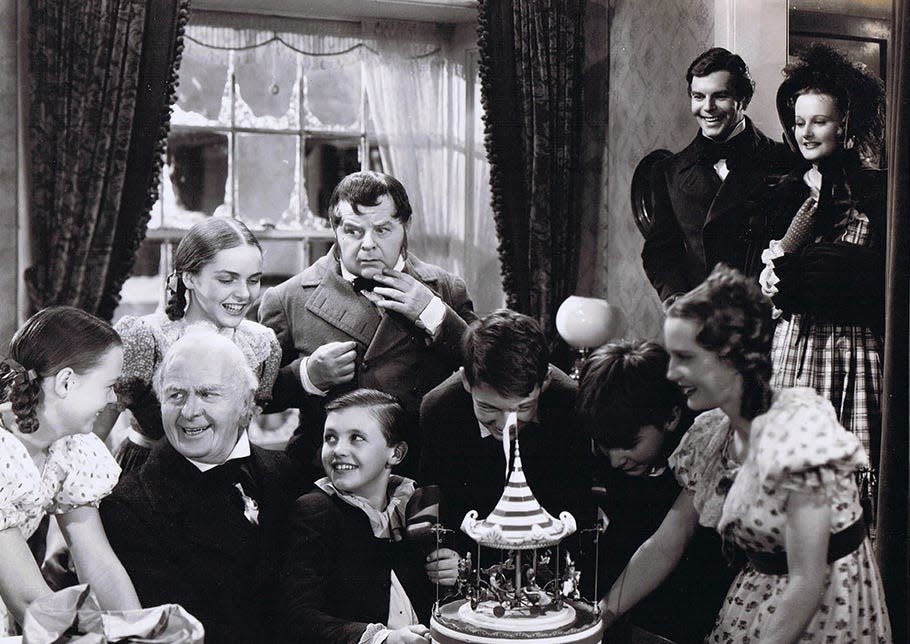 June Lockhart (L) smiles at Reginald Owen (Scrooge) at the movie's conclusion. June's father, Gene Lockhart, is in the center.