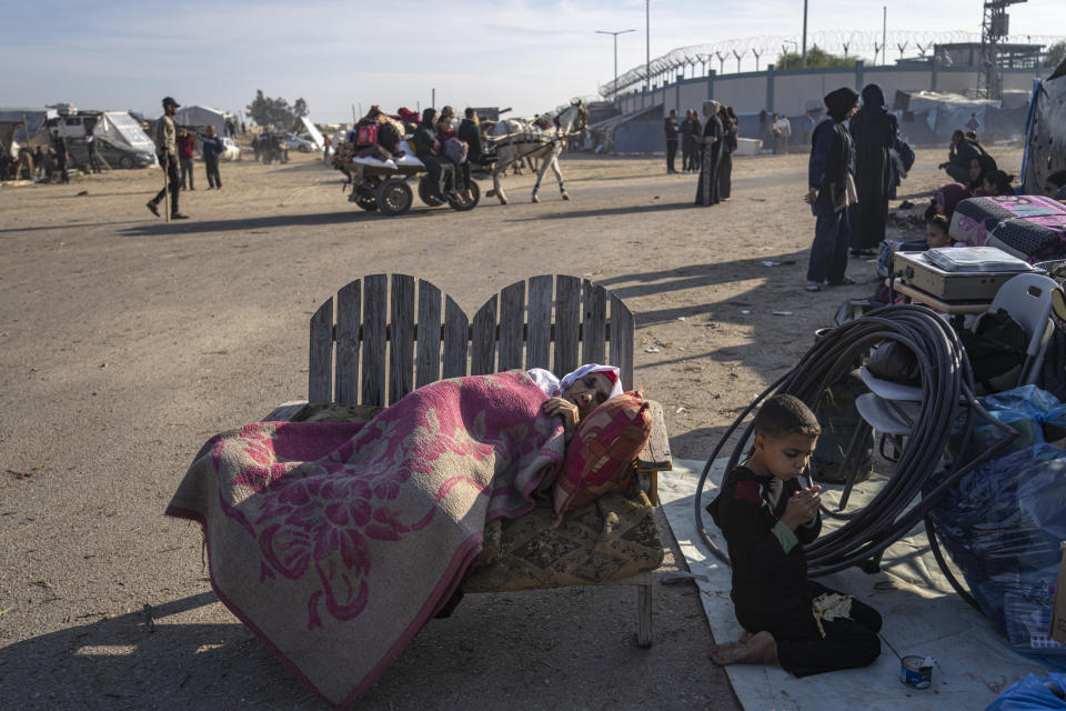 Palestinians displaced by the Israeli bombardment of the Gaza Strip gather at a tent camp, in Rafah, southern Gaza strip, Monday, Dec. 4, 2023. Hundreds of thousands of Palestinians have fled their homes as Israel moves ahead with a ground offensive against the ruling Hamas militant group. (AP Photo/Fatima Shbair)