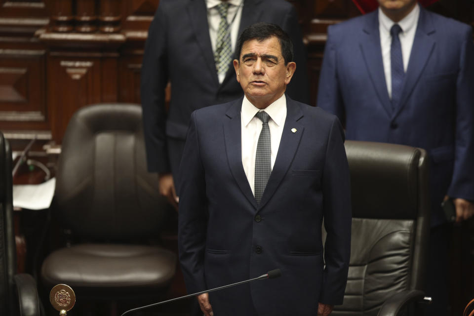 Congress President Jose Williams sings the national anthem inside Congress with other lawmakers after Peruvian President Pedro Castillo disolved the body, on the day they were planning an impeachment vote on the president in Lima, Peru, Wednesday, Dec. 7, 2022. Castillo also called for new legislative elections, before lawmakers could debate a third attempt to remove him from office. (AP Photo/Guadalupe Pardo)