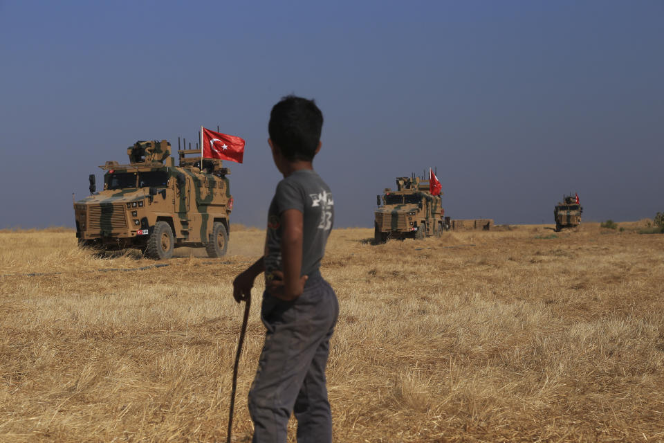 A Turkish n armored vehicles patrol as they conduct a joint ground patrol with American forces in the so-called "safe zone" on the Syrian side of the border with Turkey, near the town of Tal Abyad, northeastern Syria, Friday, Oct.4, 2019. The patrols are part of a deal reached between Turkey and the United States to ease tensions between the allies over the presence of U.S.-backed Syrian Kurdish fighters in the area. (AP Photo/Baderkhan Ahmad)