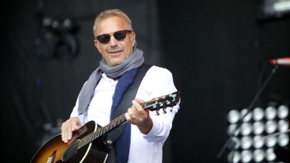 Kevin Costner & Modern West perform at the Boots & Hearts Festival in Ontario, Canada August 10th, 2012 (Photo by Michael Hurcomb/Corbis via Getty Images)