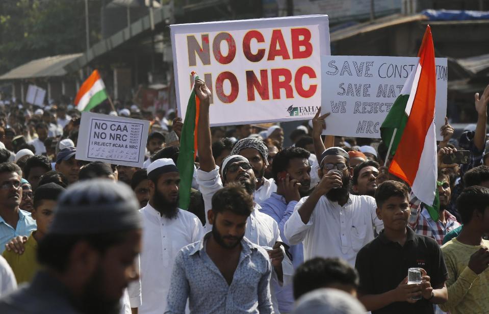Indians march during a protest against the Citizenship Act in Mumbai, India, Wednesday, Dec. 18, 2019. India's Supreme Court on Wednesday postponed hearing pleas challenging the constitutionality of the new citizenship law that has sparked opposition and massive protests across the country. (AP Photo/Rajanish Kakade)