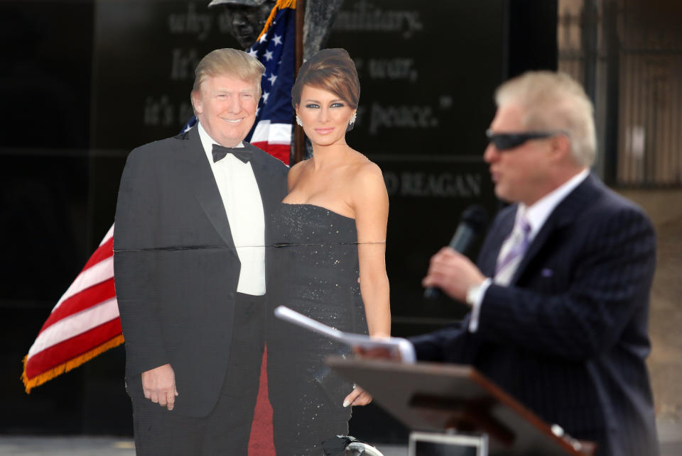 Wayne Allyn Root, USA Radio Network host, takes the podium next to a life-size cutout of Donald and Melania Trump. (Photo: Ronda Churchill for Yahoo)