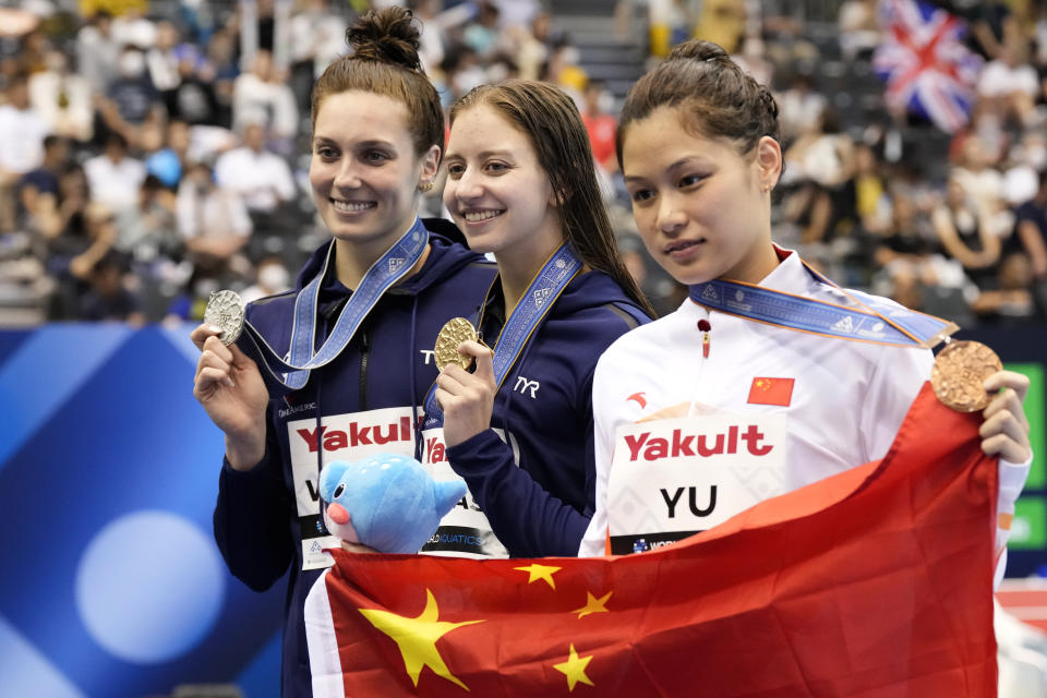 Gold medalist Kate Douglass of United States, center, is flanked by silver medalist Alex Walsh of United States, left, and bronze medalist Yu Yiting of China as they pose during the medals ceremony of the women's 200m medley final at the World Swimming Championships in Fukuoka, Japan, Monday, July 24, 2023. (AP Photo/Lee Jin-man)