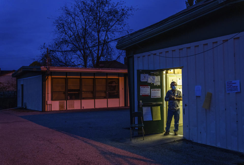 Majority Clerk Andrew O'Neill waits for voters at the door of a polling place at Pittsburgh Brookline K-8 on Tuesday, Nov. 2, 2021, in Pittsburgh. (Andrew Rush/Pittsburgh Post-Gazette via AP)