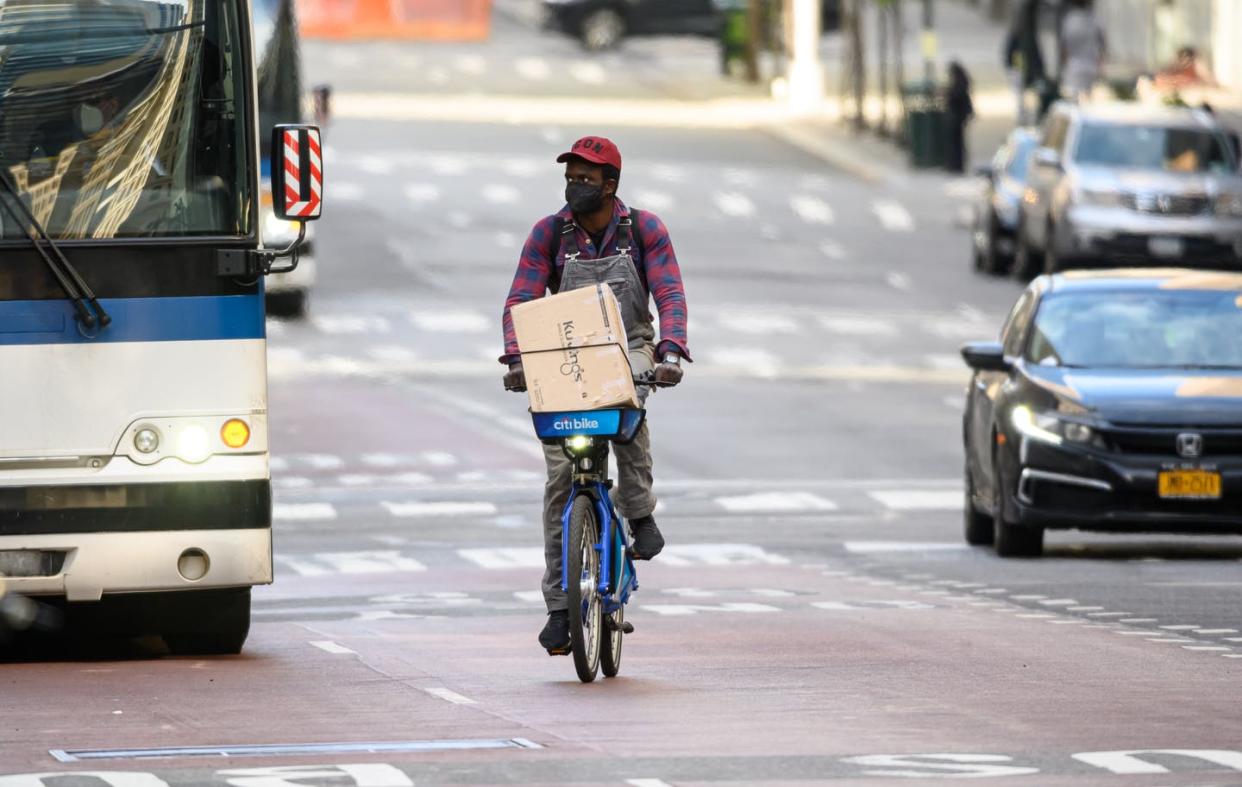 <span class="caption">A cyclist uses New York's bike-share program.</span> <span class="attribution"><a class="link " href="https://www.gettyimages.com/detail/news-photo/person-wears-a-protective-face-mask-while-riding-a-bicycle-news-photo/1226132131?adppopup=true" rel="nofollow noopener" target="_blank" data-ylk="slk:Noam Galai/Getty Images;elm:context_link;itc:0;sec:content-canvas">Noam Galai/Getty Images</a></span>