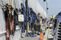 Crew members' fire suits dry out in the garage area before the restart of the NASCAR Daytona 500 auto race at Daytona International Speedway, Monday, Feb. 17, 2020, in Daytona Beach, Fla. Sunday's race was postponed because of rain. (AP Photo/Terry Renna)