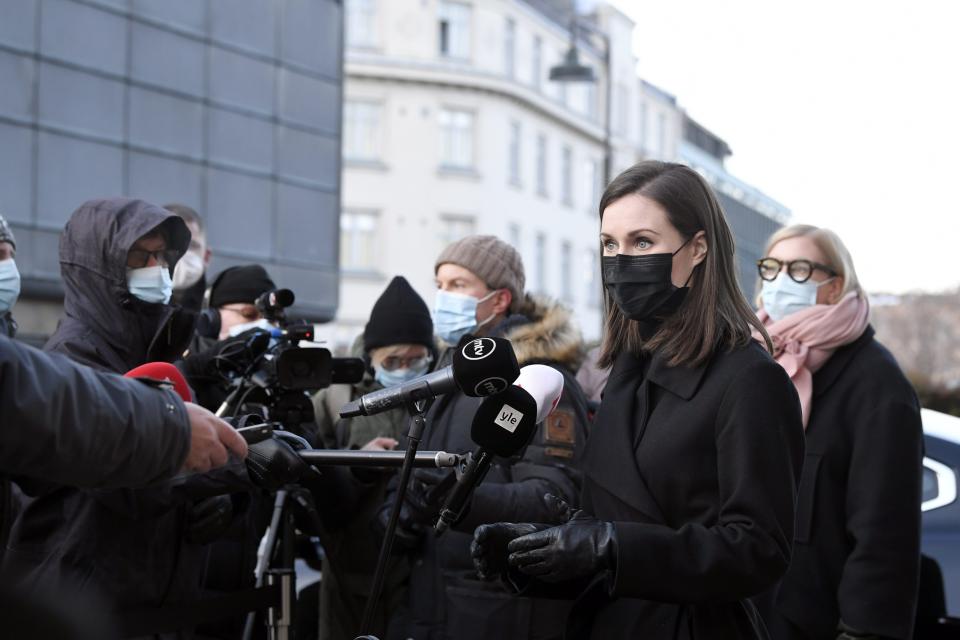 Finnish Prime Minister Sanna Marin meets with media outside the Finnish Parliament building in Helsinki, Finland, Wednesday, Dec. 8, 2021