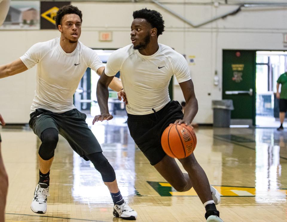Shamir Bogues dribbles past Jace Roquemore during a UVM men's basketball summer practice earlier this month at Patrick Gym.