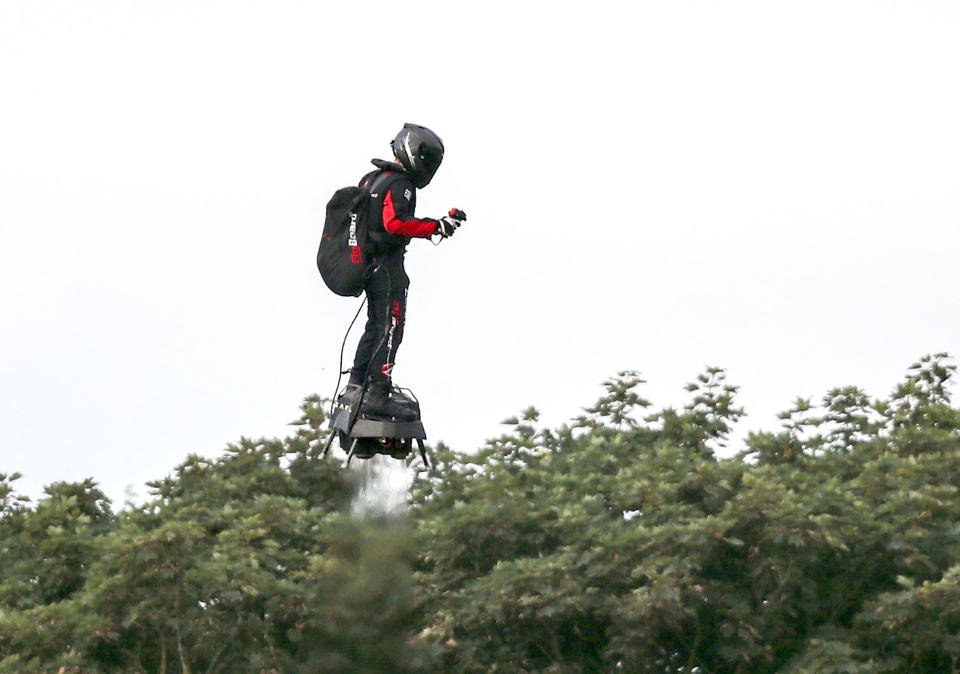 French inventor Franky Zapata flies near St. Margaret's beach, Dover after crossing the Channel on a flying board Sunday, Aug. 4, 2019. (Steve Parsons/PA via AP)