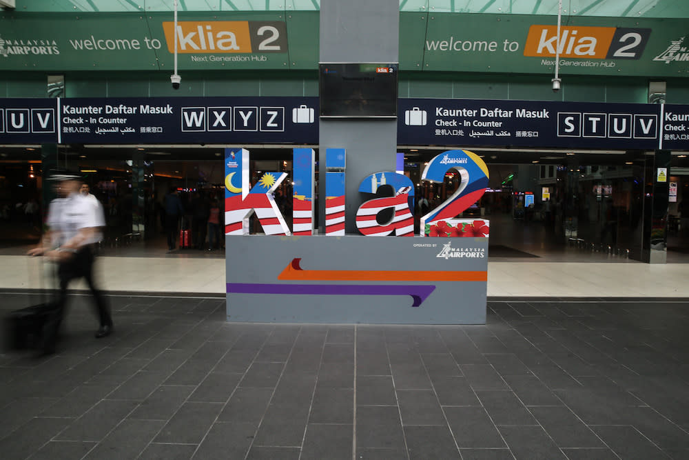 A man walks past a KLIA2 display in Sepang August 22, 2019. — Picture by Yusof Mat Isa