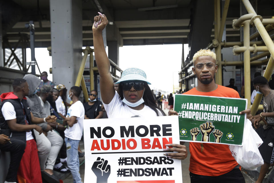 FILE- People hold banners as they demonstrate on the street to protest against police brutality in Lagos, Nigeria, Thursday, Oct. 15, 2020. In a report submitted to Lagos Governor Babajide Sanwo-Olu on Monday, Nov. 15, 2021, a Nigerian judicial panel has found that soldiers of the Nigerian army "shot, injured and killed" protesters during the Oct. 2020 nationwide demonstrations against police brutality in the country's most populous city Lagos. (AP Photo/Sunday Alamba, File)