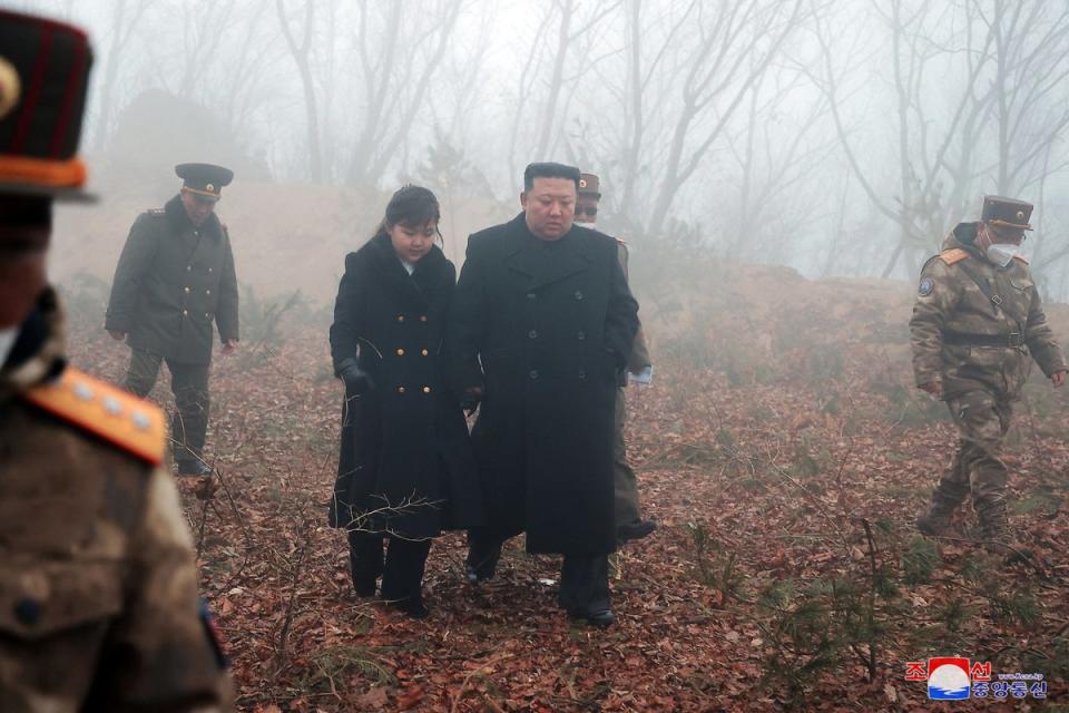 North Korean leader Kim Jong-un walks with his daughter Kim Ju-ae at an undisclosed location in this image released on 20 March (via REUTERS)