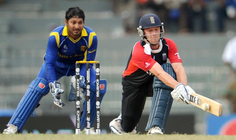 Jonathon Trott (right) plays a reverse sweep as Sri Lankan wicketkeeper Kumar Sangakkara looks on in the World Cup quarter-final at The R. Premadasa Cricket Stadium in Colombo on March 26, 2011