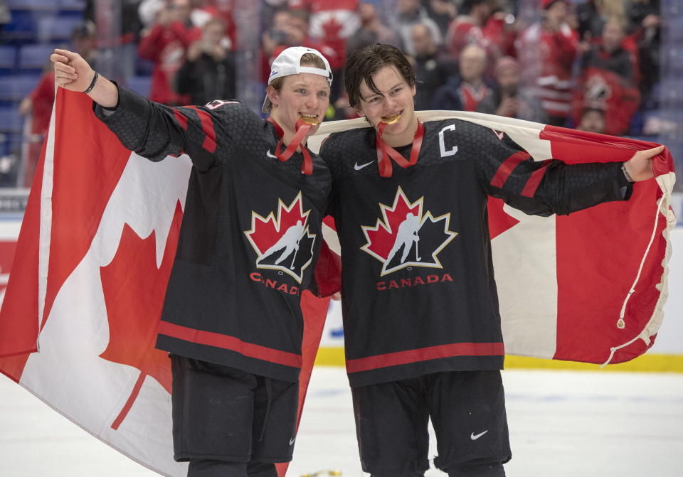 Canada captain Barrett Hayton, right, and Ty Dallandrea celebrate after defeating Russia in the gold medal game at the World Junior Hockey Championships, Sunday, Jan. 5, 2020, in Ostrava, Czech Republic. (Ryan Remiorz/The Canadian Press via AP)