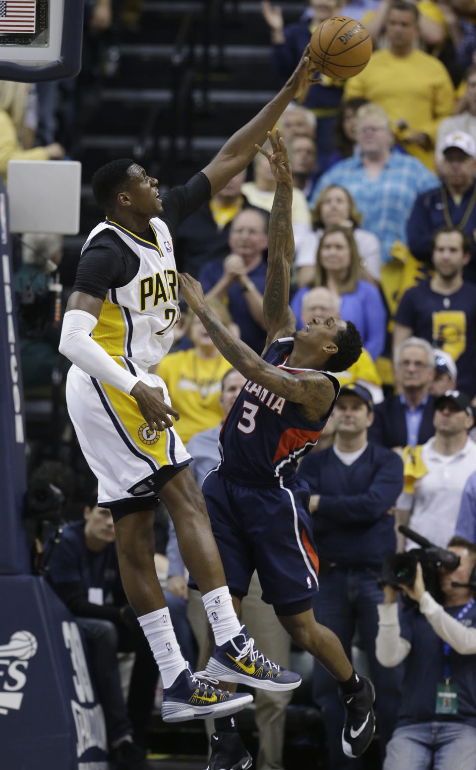 Atlanta Hawks' Louis Williams (3) has his shot blocked by Indiana Pacers' Ian Mahinmi (28) during the second half in Game 2 of an opening-round NBA basketball playoff series Tuesday, April 22, 2014, in Indianapolis. Indiana defeated Atlanta 101-85. (AP Photo/Darron Cummings)
