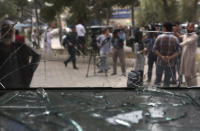 <p>Afghan journalists stand in front of the broken glass of shop at the site of a suicide bombing in Kabul, Afghanistan, Tuesday, Aug. 29, 2017. (Photo: Rahmat Gul/AP) </p>