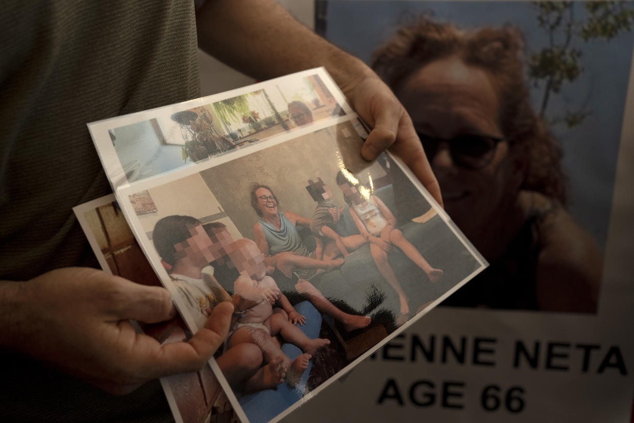 Nahal Neta, son of Adrienne Neta, holds a photo of the nurse living in Kibbutz Be'eri missing since a Hamas surprise attack 