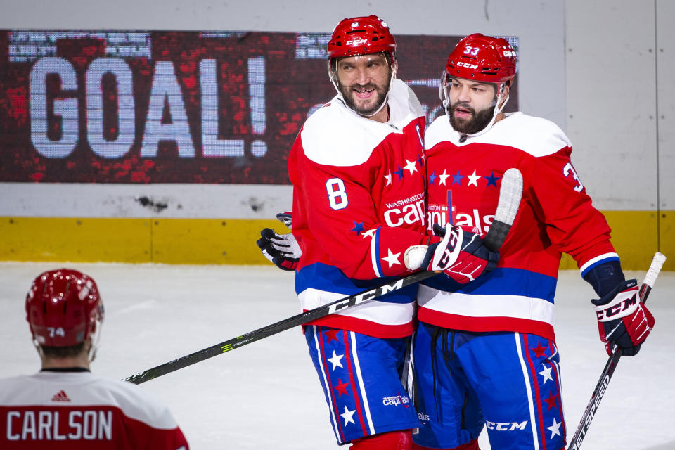 Washington Capitals left wing Alex Ovechkin (8), from Russia, is hugged by defenseman Radko Gudas (33), from Czech Republic, after scoring during the first period of an NHL hockey game against the New Jersey Devils, Thursday, Jan. 16, 2020, in Washington. (AP Photo/Al Drago)