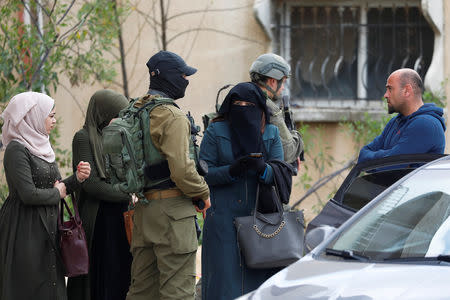 Israeli forces stop Palestinians during a search for a gunman near Nablus, in the Israeli-occupied West Bank March 17, 2019. REUTERS/Mohamad Torokman