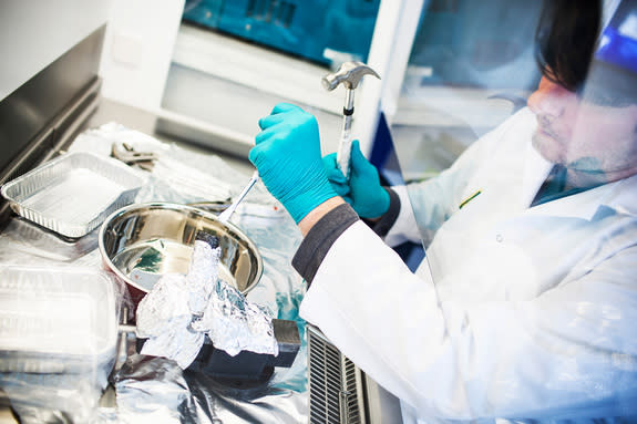 Microbiologist Mark Lever works with rock samples from the ocean floor.