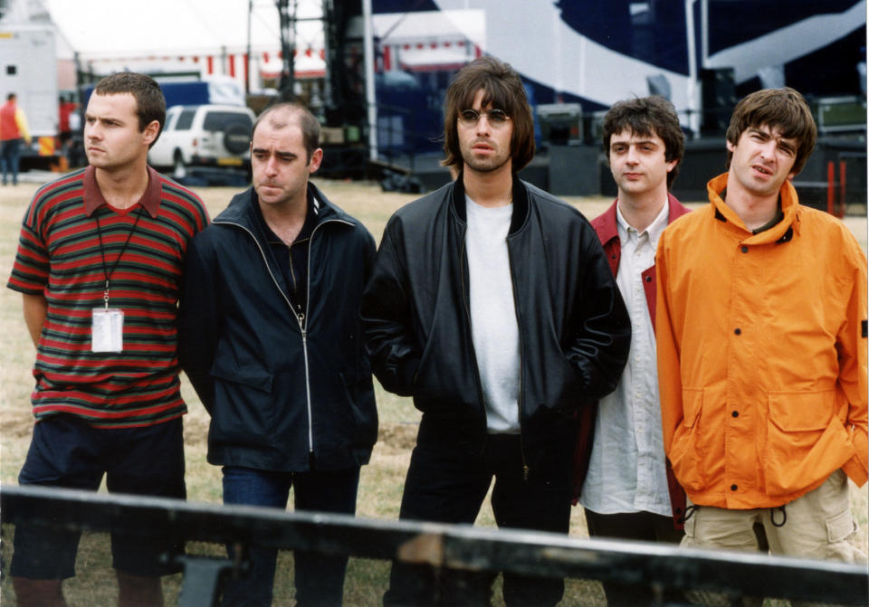 7th MAY : On this day in 1995 rock group Oasis were top of the charts with their first number one, 'Some might Say'. The band Oasis line up before their Knebworth Park concert. (l-r) drummer Alan White, rhythm guitarist Paul 