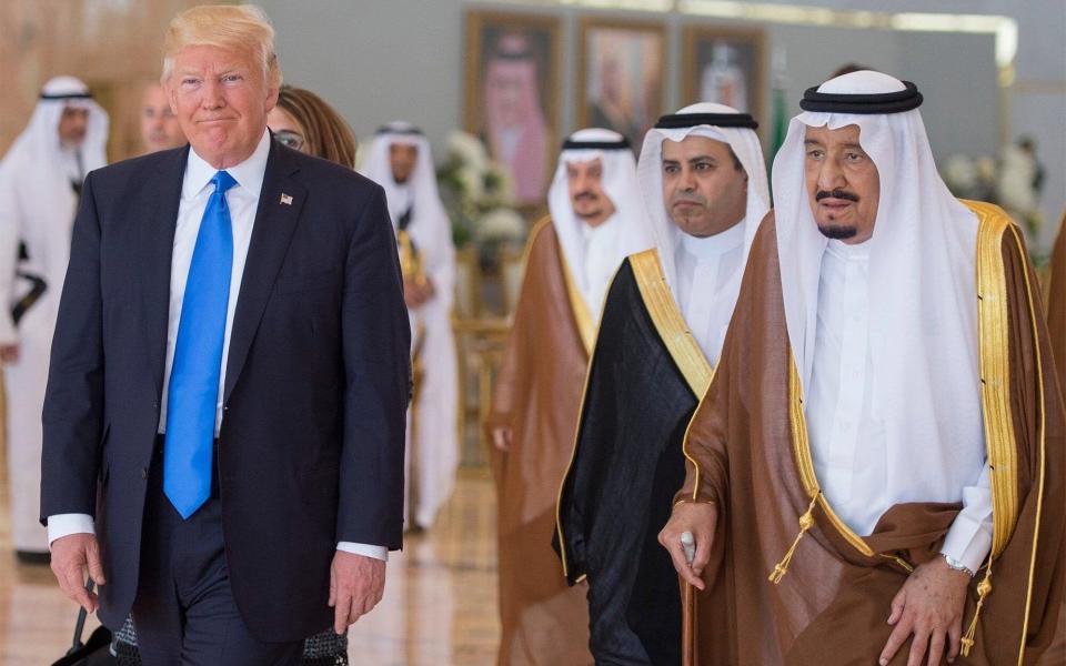 A handout photo made available by the Saudi Press Agency shows US President Donald J. Trump (L) after being welcomed by Saudi Arabia's King Salman bin Abdulaziz Al Saud (R) at King Khalid International Airport in Riyadh