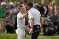 Rory McIlroy, of Northern Ireland, greets Michael Block after their final round of the PGA Championship golf tournament at Oak Hill Country Club on Sunday, May 21, 2023, in Pittsford, N.Y. (AP Photo/Abbie Parr)