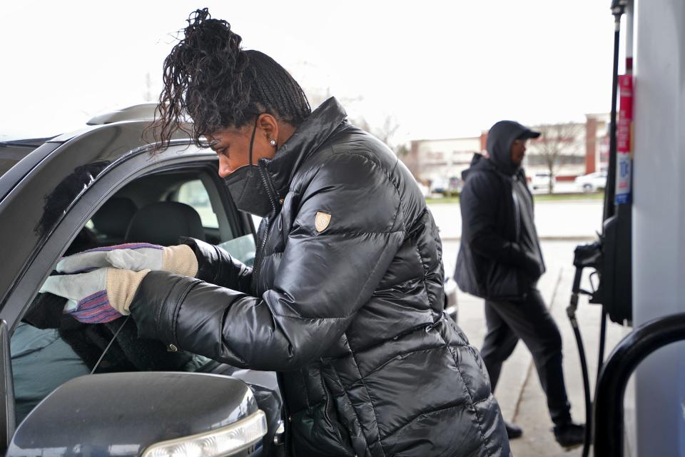 Pastor Patricia Germany prays for a woman as she gets free gas during the Kingdom Apostolic Ministries' Free Gas Giveaway, Thursday, March 31, 2022 at the Marathon station located at 5060 East 38th St. Lines of vehicles awaited their turn to get $20 of free gas. The church gave $5000 worth of free gas to people, and prayers when requested.
