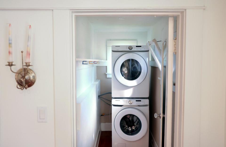 A view through a door into a small laundry room that is sometimes used as an art gallery.