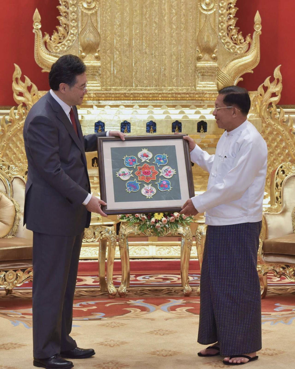 In this photo provided by the Myanmar Military True News Information Team, Senior Gen. Min Aung Hlaing, right, head of the military council, exchanges gift with Chinese Foreign Minister Qin Gang, left, during their meeting Tuesday, May 2, 2023, in Naypyitaw, Myanmar.The head of Myanmar's military-controlled government, Senior Gen. Min Aung Hlaing, met Tuesday with the visiting foreign minister of China, one of the army regime's closest allies offering key support to its continued rule since seizing power two years ago. (Military True News Information Team via AP)