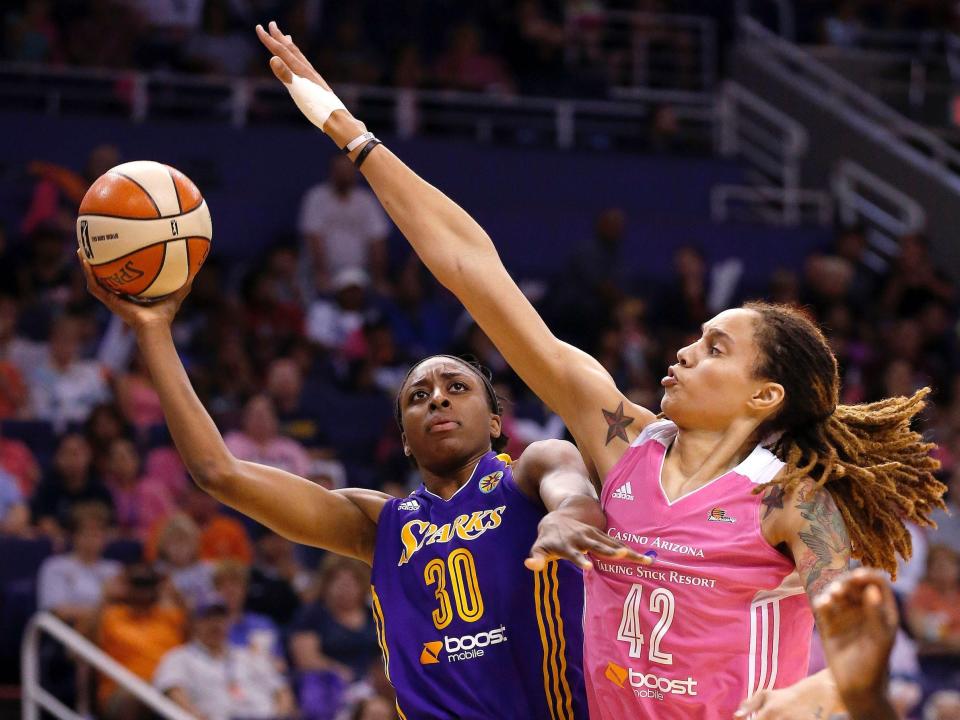 Griner (right) defends Nneka Ogwumike during a 2014 game between the Mercury and Ogwumike's Los Angeles Sparks.