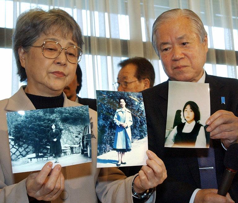 Parents of abducted daughter to North Korea in 1977, show portraits of their daughter at a press conference in Tokyo, Japan, on November 16, 2004