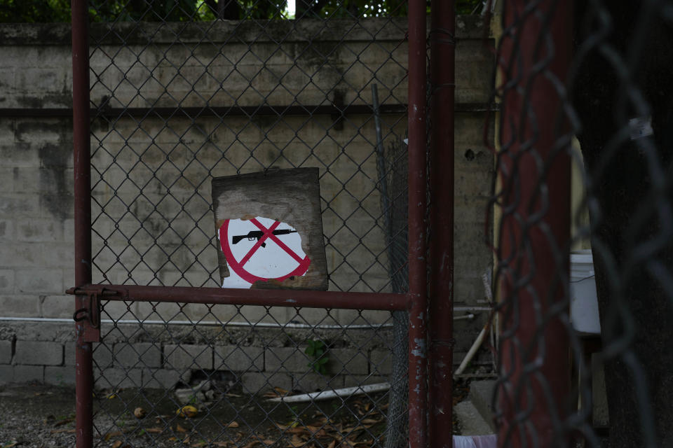 A no firearms allowed sign hangs on a fence at an emergency room run by Doctors Without Borders in the Cite Soleil district of Port-au-Prince, Haiti, Wednesday, May 31, 2023. The international medical humanitarian organization had temporarily suspended activities due to the escalating violence in the Haitian capital. (AP Photo/Ariana Cubillos)