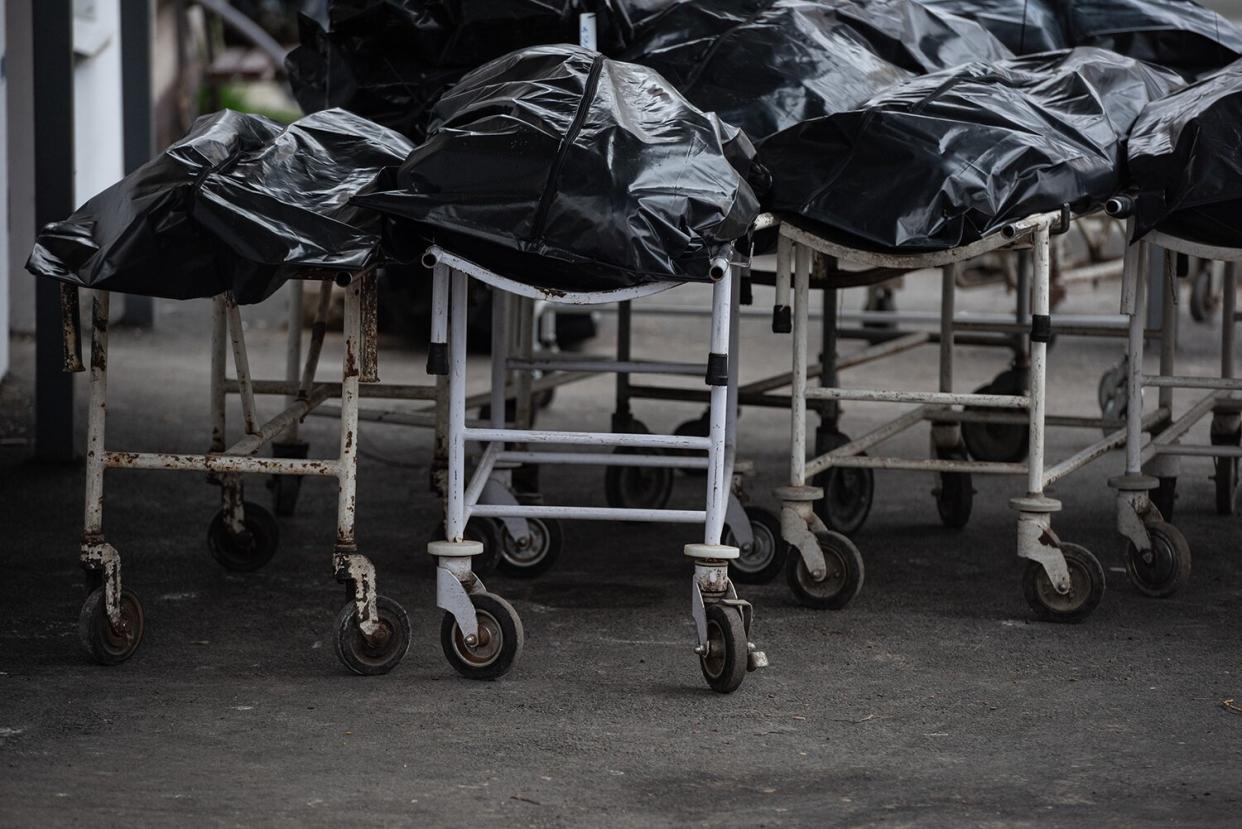 Body bags are seen by the morgue building on April 18, 2022 in Bucha, Ukraine. The Kyiv suburb was heavily damaged in fighting between invading Russian forces and Ukrainian troops weeks before.