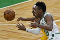 Boston Celtics forward Aaron Nesmith (26) and Indiana Pacers guard Aaron Holiday, back, chase the ball in the first half of an NBA basketball game, Friday, Feb. 26, 2021, in Boston. (AP Photo/Elise Amendola)