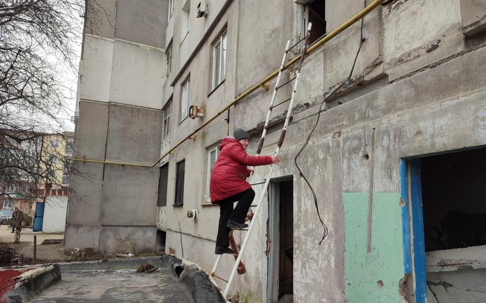 Liudmyla Hranova, 71, can only access her apartment in Luch, Mykolaiv, using a ladder after a Russian air strike destroyed the block's entrance