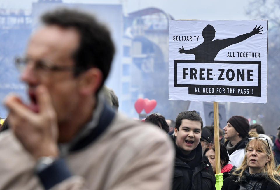 Demonstrators march during a protest against coronavirus measures in Brussels, Belgium, Sunday, Dec. 5, 2021. Hundreds of people marched through central Brussels on Sunday to protest tightened COVID-19 restrictions imposed by the Belgian government to counter the latest spike in coronavirus cases. (AP Photo/Geert Vanden Wijngaert)